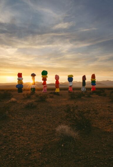 a group of balloons sitting in the middle of a field